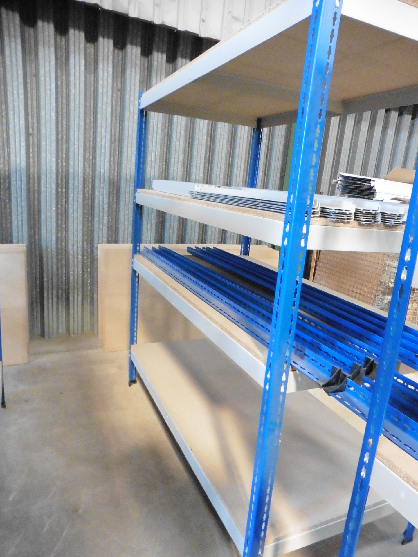 5 bays of blue and grey medium duty 4 shelf racks with chipboard shelves, each bay 1830 x 930 x