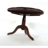 An 18th century circular oak table on a tripod base, reduced in height, d.