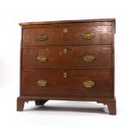 A George III oak and crossbanded chest of three long drawers on bracket feet, w.