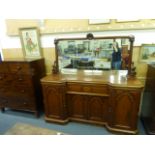 A Victorian mahogany break-front sideboard with a mirrored back over one drawer and four doors on a