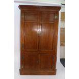 An 18th century oak corner cupboard, the four panelled doors enclosing shelves, on a plinth base, w.