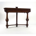 An 18th century-type oak side table, the canted surface with a shield back,