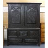 An 18th century and later black painted oak linen press,