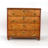 A 19th century continental birch chest of four long graduated drawers on turned feet, w.