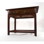 An 18th century oak side table with a single frieze drawer over a shaped apron on square straight