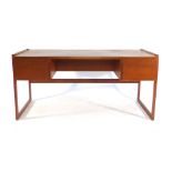 A 1970's teak desk with an arrangement on four drawer with a gallery section to the rear on square