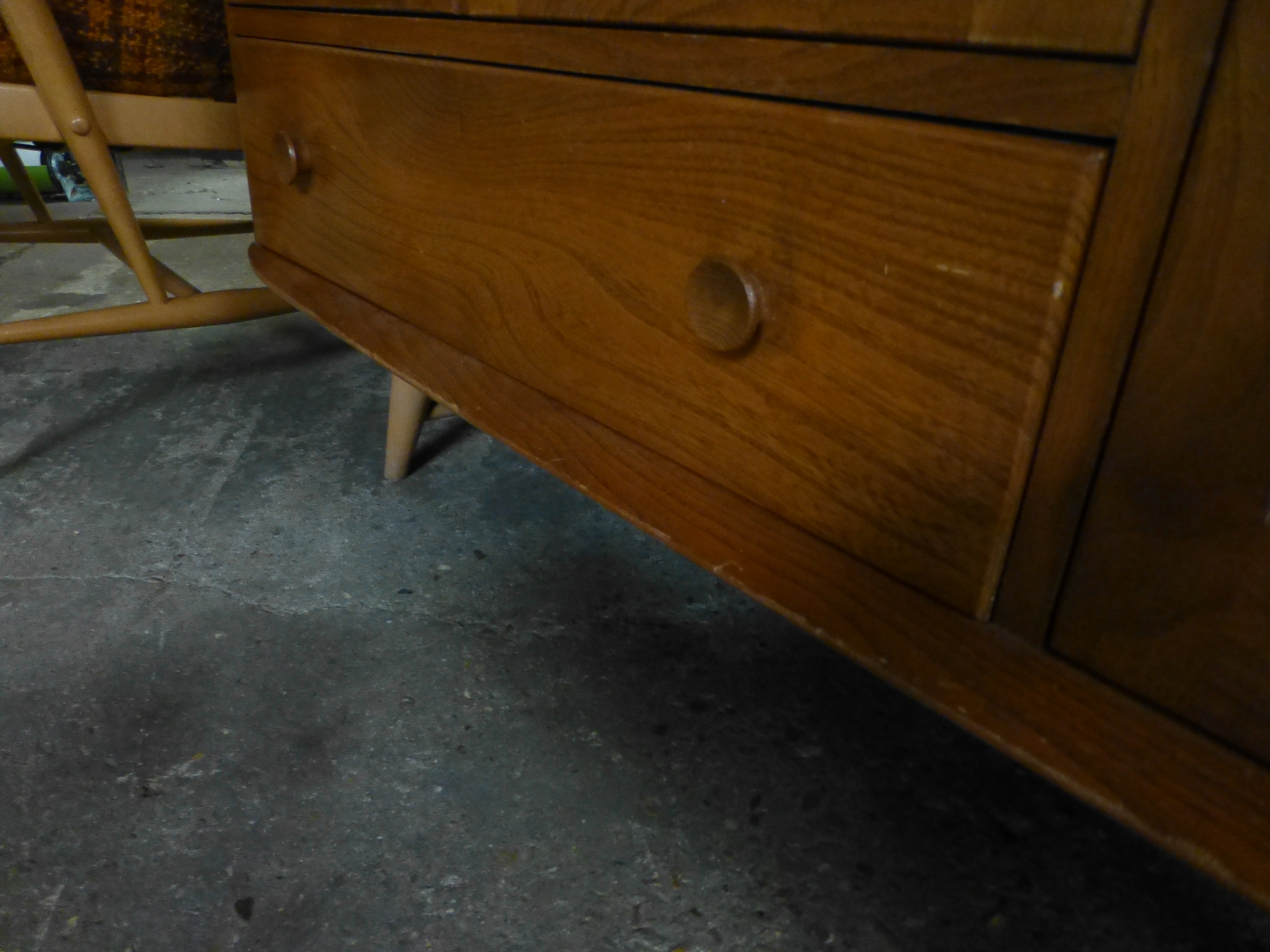 An Ercol elm and beech sideboard with an arrangement of three doors one drawers on tapering legs. w. - Image 4 of 7