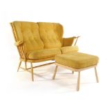 An Ercol beech and upholstered two seater sofa together with a matching footstool
