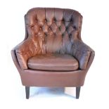 A brown button upholstered lounge armchair on mahogany straight tapering feet