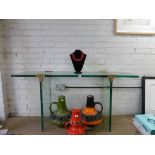 A 1970's glass console table constructed of three 'slabs' with brass supports, by Peter Ghyczy, l.