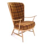 An Ercol beech and upholstered highback lounge armchair on tapering legs.