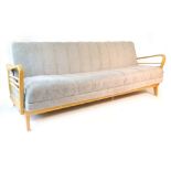 A 1950/60's beech and upholstered sofa bed with arms of organic form CONDITION REPORT: