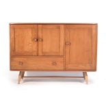 An Ercol elm and beech sideboard with an arrangement of three doors one drawers on tapering legs. w.