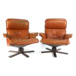 A pair of 1970's burgundy lounge armchairs on laminate five star bases CONDITION REPORT: