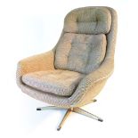 A 1970's oatmeal and button upholstered armchair on an aluminium five star base