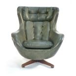 A 1970's green vinyl and button upholstered egg-type chair a teak four star base