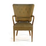 A 1940's Danish beech framed and button upholstered highback lounge armchair on square tapering