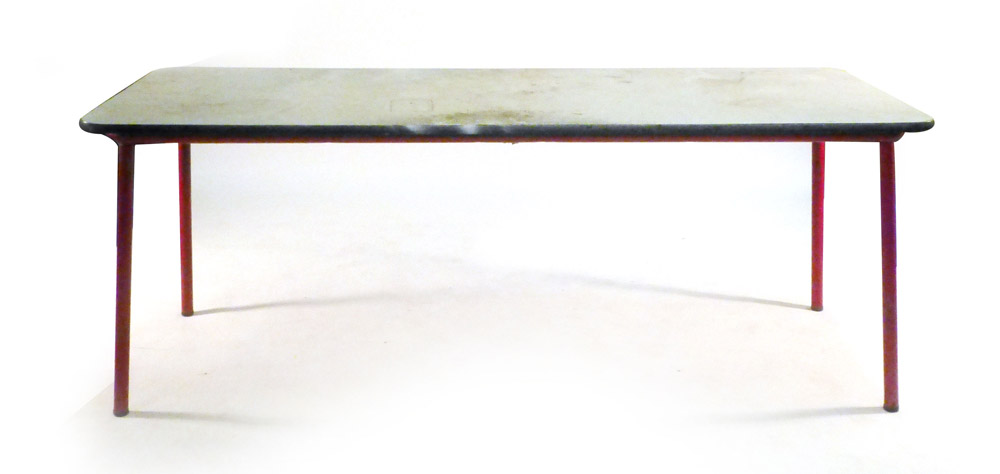 A 1950's French classroom/industrial table, on four red enamelled red tapering legs, l.