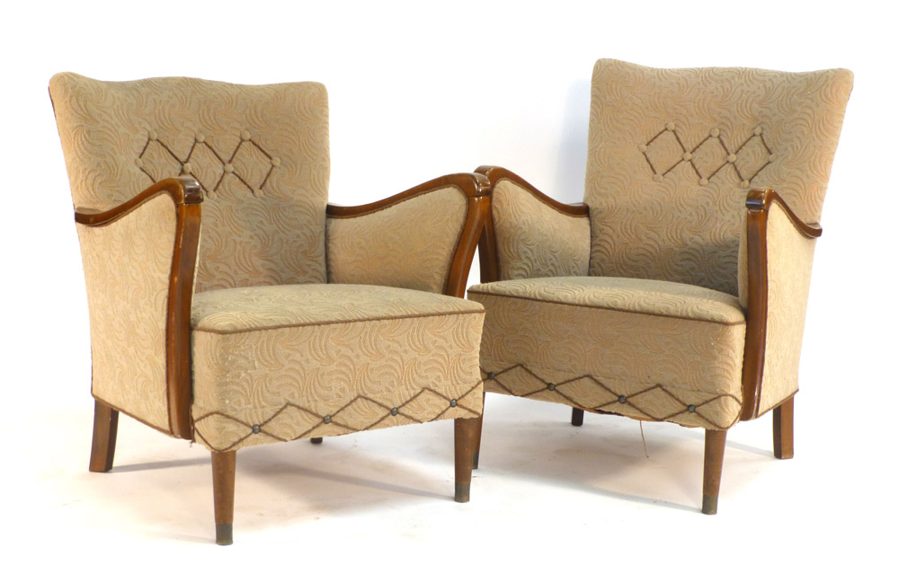 A 1940's fully upholstered three piece suite with exposed beech frames on tapering legs terminating