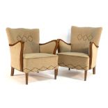 A 1940's fully upholstered three piece suite with exposed beech frames on tapering legs terminating