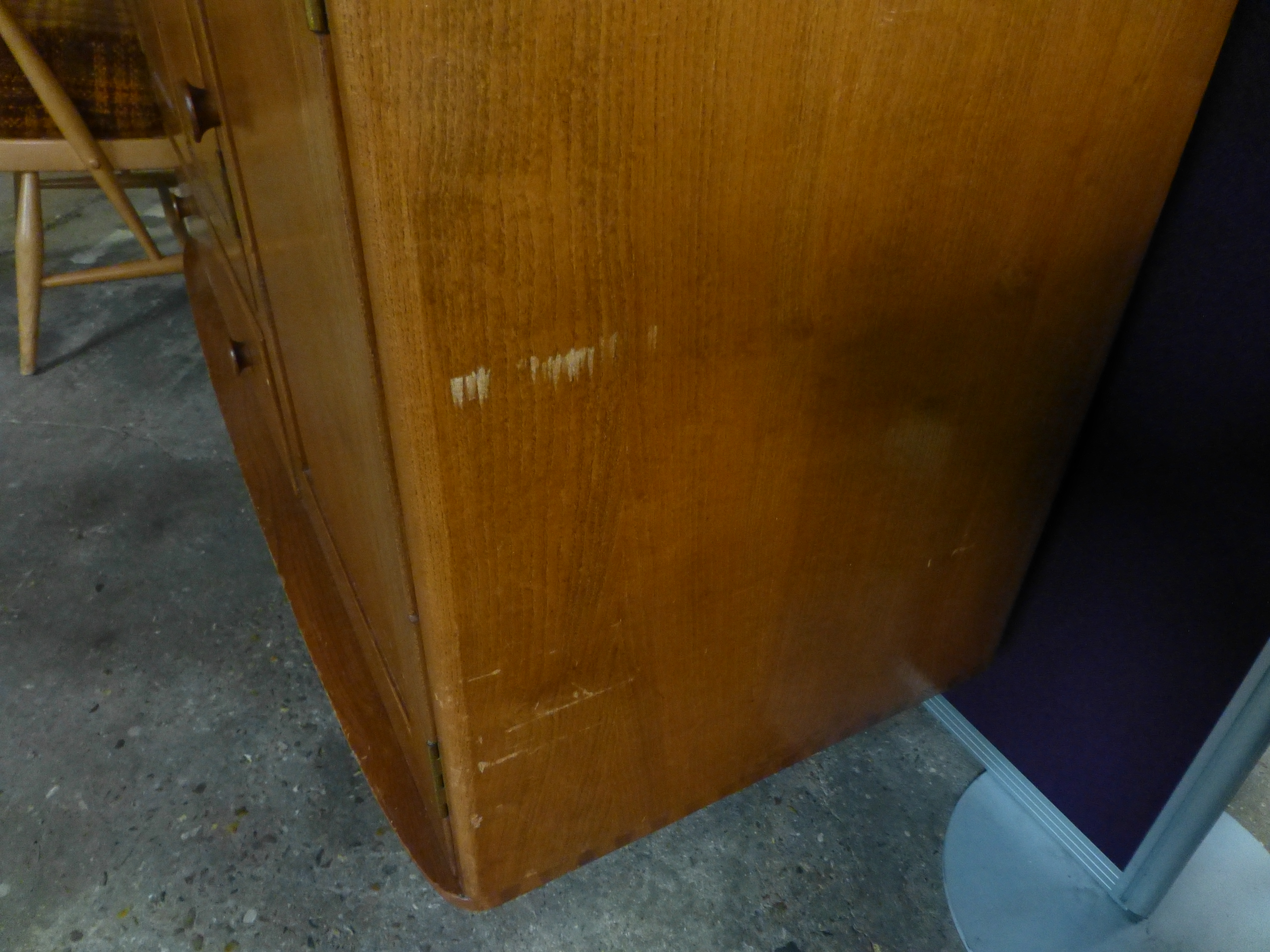 An Ercol elm and beech sideboard with an arrangement of three doors one drawers on tapering legs. w. - Image 2 of 7