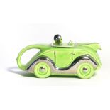A Sadler teapot in the form of a green and silvered racing car, registration 'OKT42', l.
