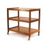 A G-Plan-type teak three tier trolley on casters, l.