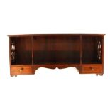 An Edwardian mahogany wall shelf with fretwork panels, turned supports and two drawers, w.