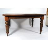 A Victorian oak extending dining table on turned supports, l.