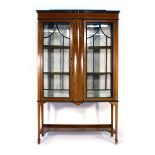 An Edwardian mahogany and inlaid partially bow-fronted display cabinet,