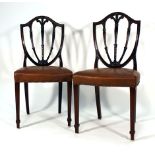 A set of nine 19th century mahogany and vinyl upholstered Hepplewhite-type dining chairs on reeded