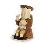 A Leonard Jarvis limited edition creamware toby jug modelled as a seated Winston Churchill,