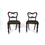 A set of six Victorian mahogany and upholstered dining chairs on turned front legs