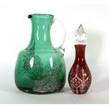 An emerald green and clear glass water jug of squat form internally decorated with bubbles,