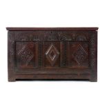 A 17th century and later oak carved and panelled coffer on square straight stiles, l.