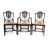 A set of eight late 18th/early 19th century Hepplewhite-type mahogany and upholstered dining chairs