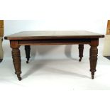 A Victorian mahogany extending dining table, with three fitted leaves, on turned legs, max. l.
