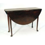 An 18th century-type mahogany drop-leaf dining table of oval form on circular tapering legs with