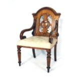 A Victorian oak hall armchair, the back inset with a shield,