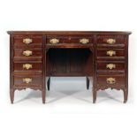 An Edwardian and later mahogany kneehole desk with an arrangement of nine drawers on square block