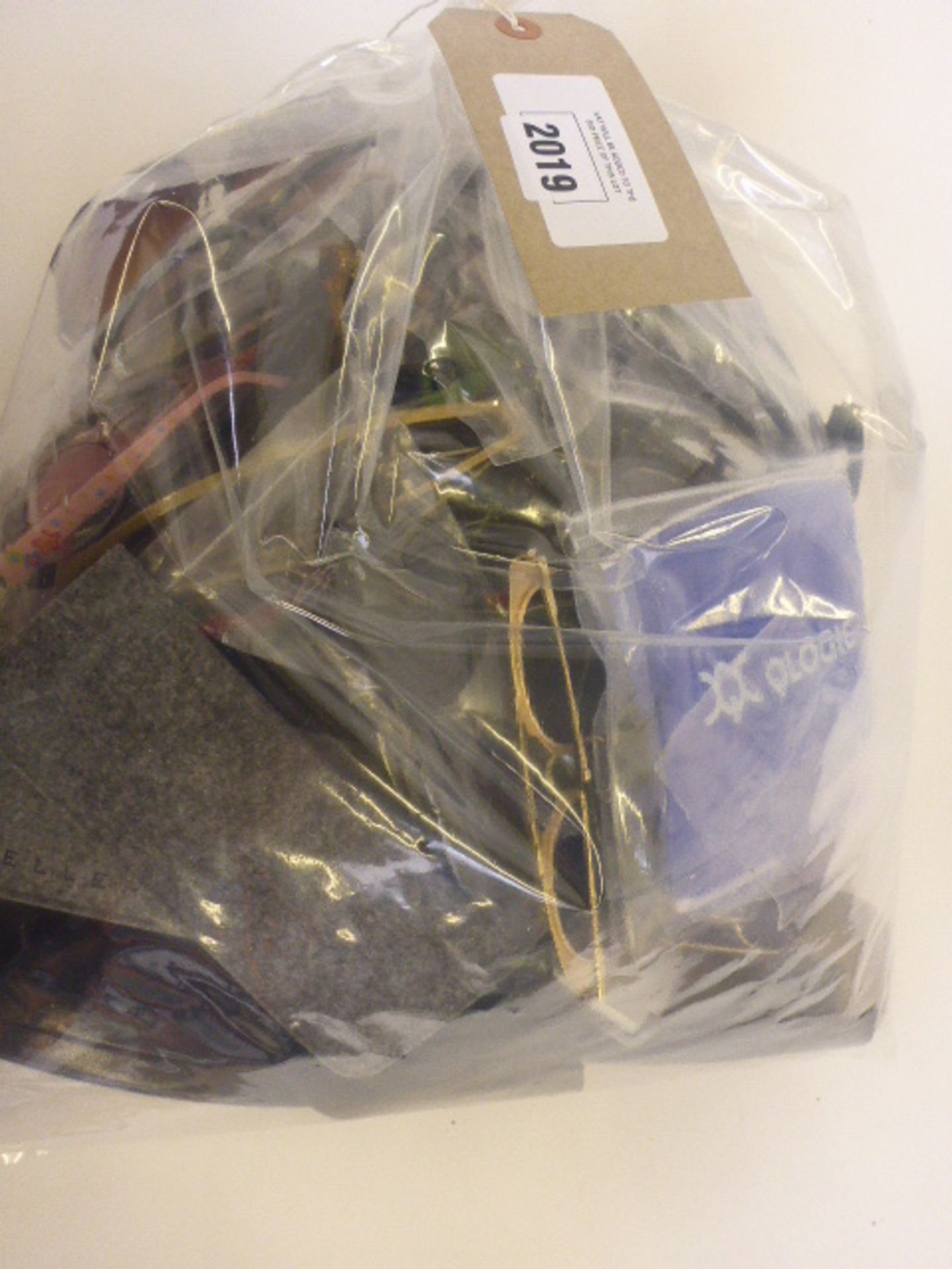 Bag containing various sunglasses, reading glasses and glasses cases