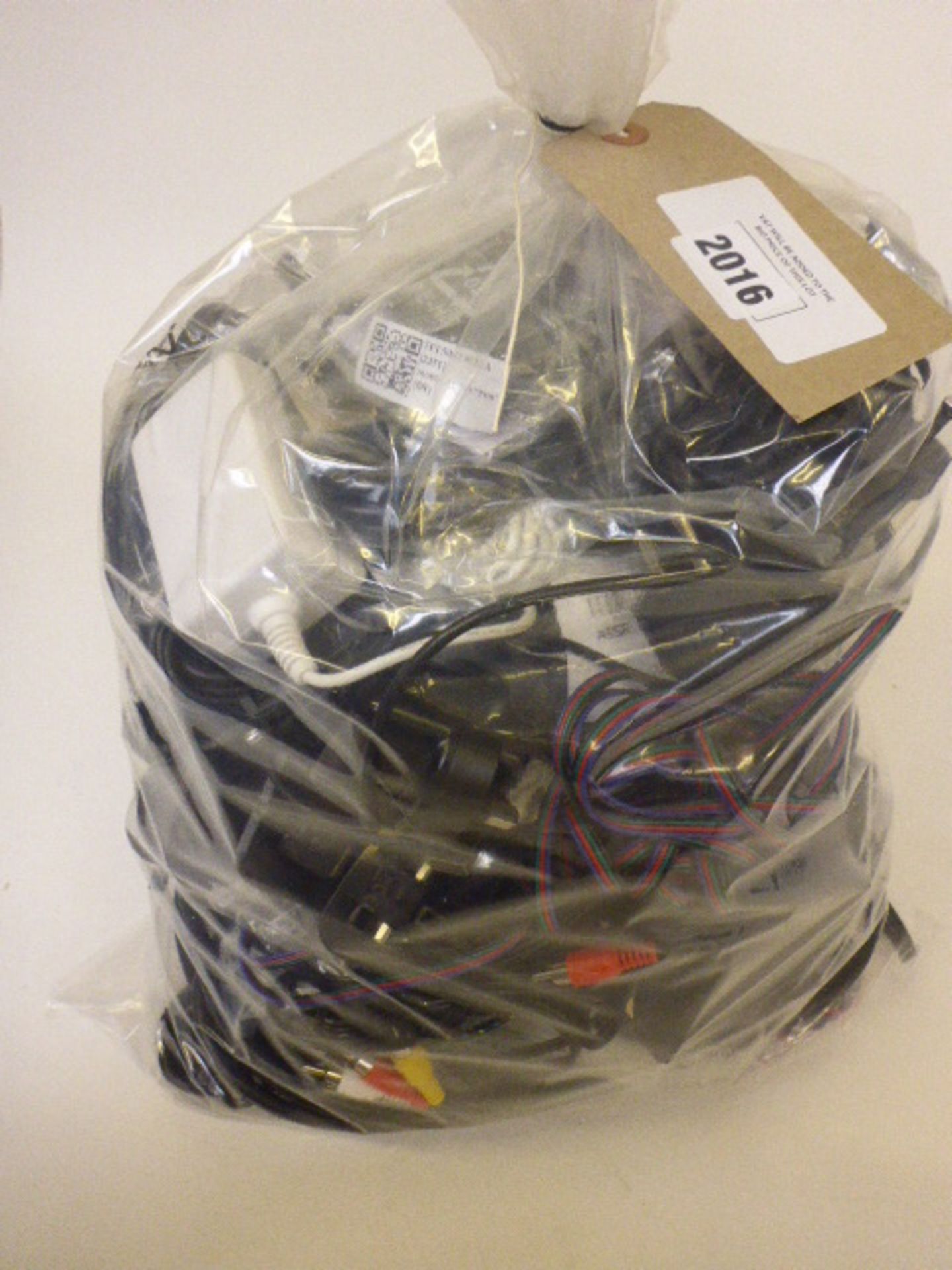 Bag containing assorted power supplies, cables and leads