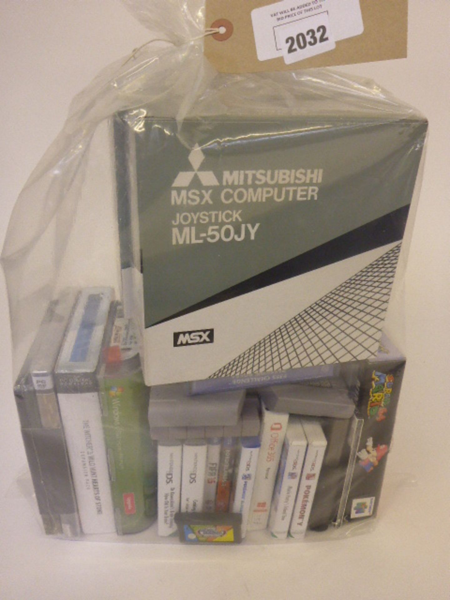 A bag containing various PS games, including Nintendo, PS Vista, and joysticks