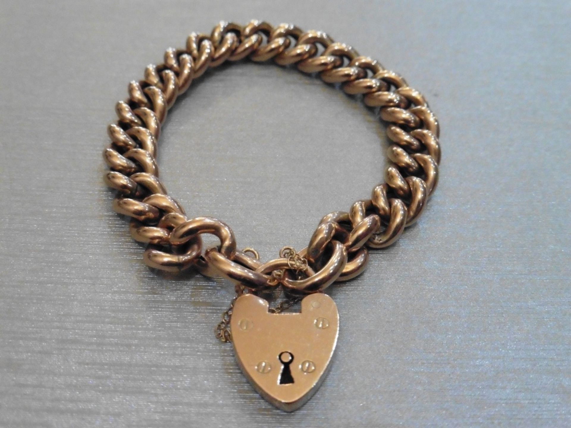 Pre-owned 9ct rose gold victorian style bracelet.  Hollow links with heart locket fastner and safety