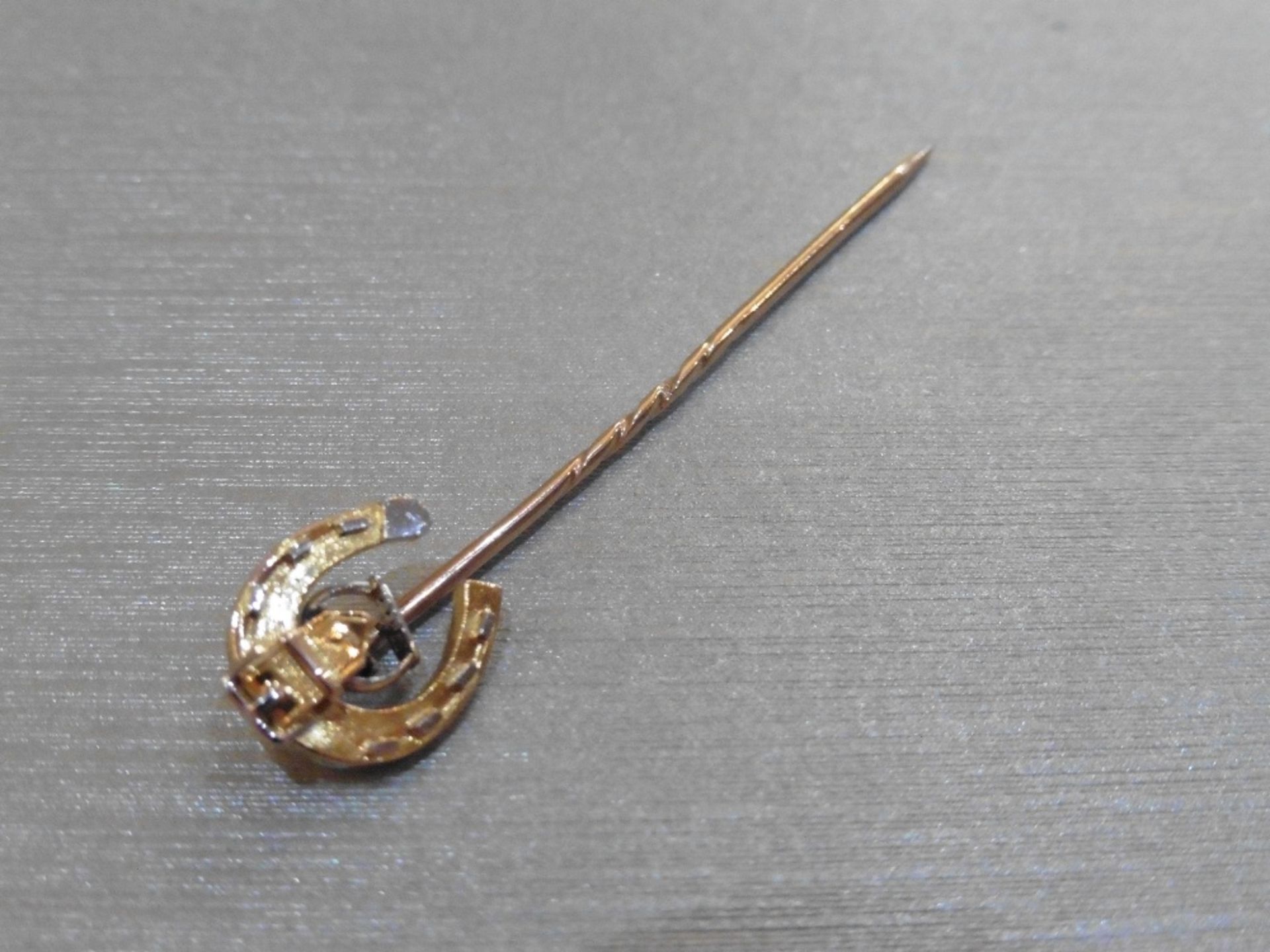 Pre-owned 9ct gold tie pin.  Horse shoe motif at the end with small sections of white gold and