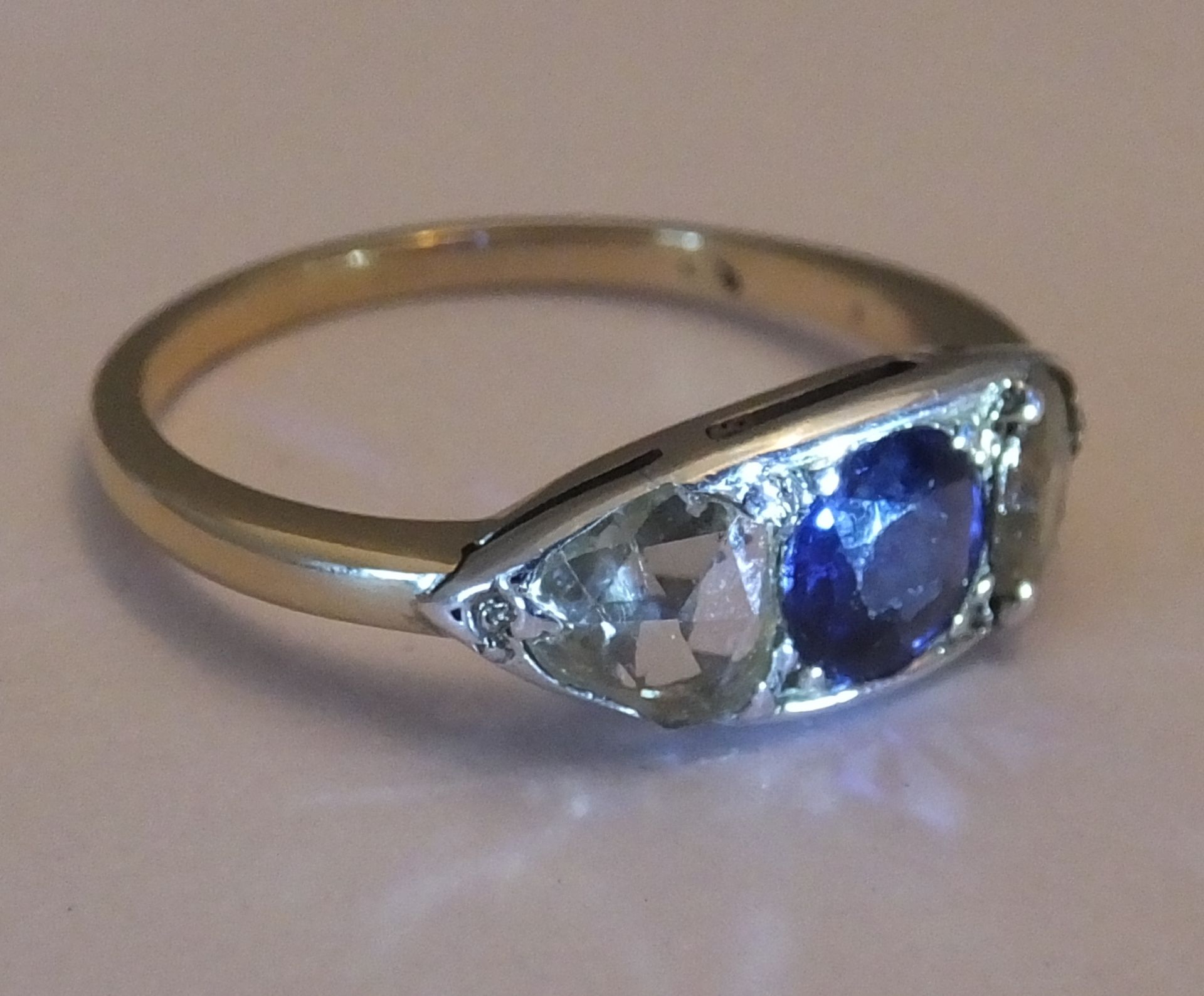A sapphire and diamond three-stone ring. Size L - The circular-shape sapphire, with triangular-shape - Image 2 of 3