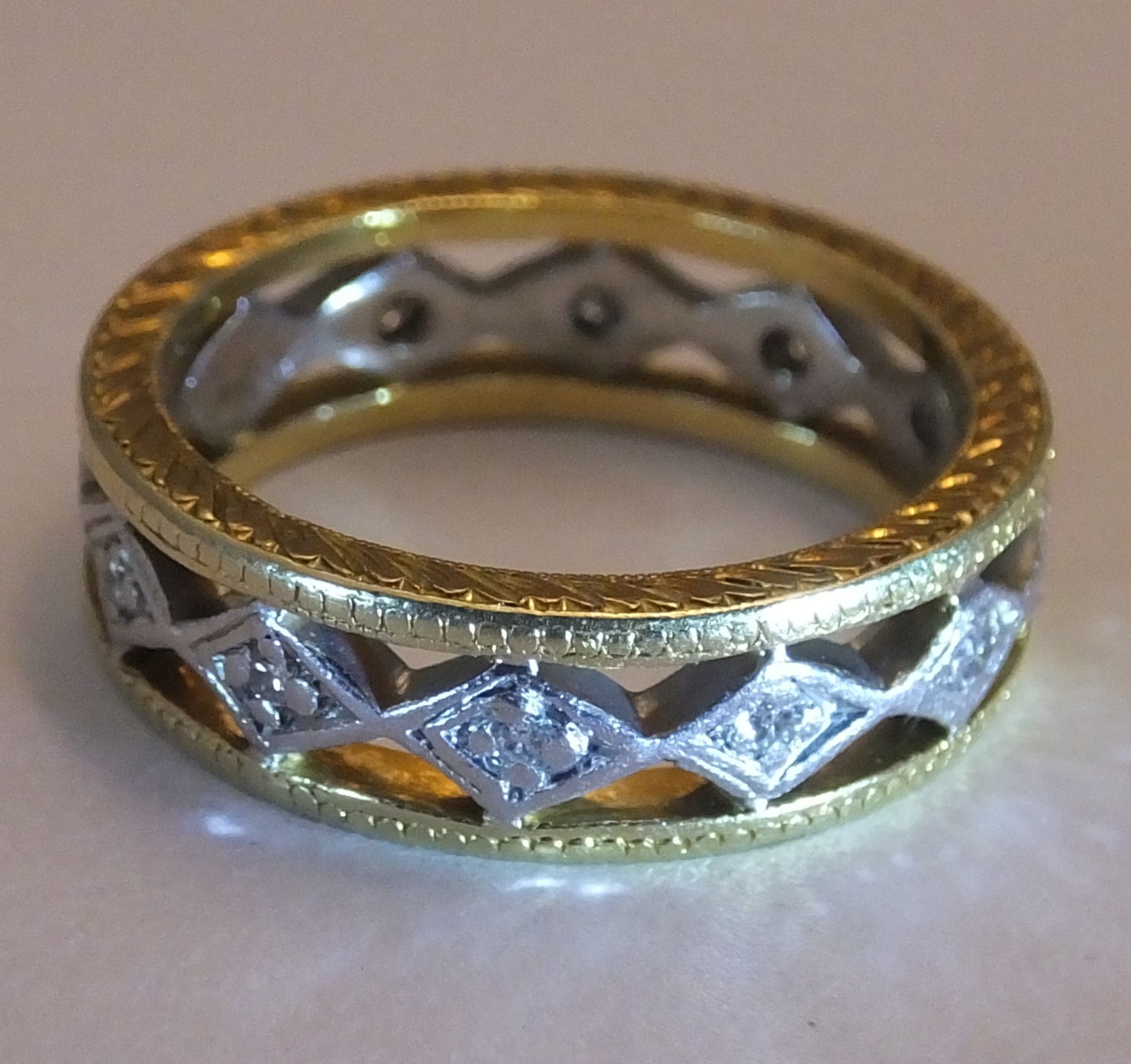 A 18CT Gold diamond full-circle eternity ring. Of bi-colour openwork design, the brilliant-cut - Image 2 of 3