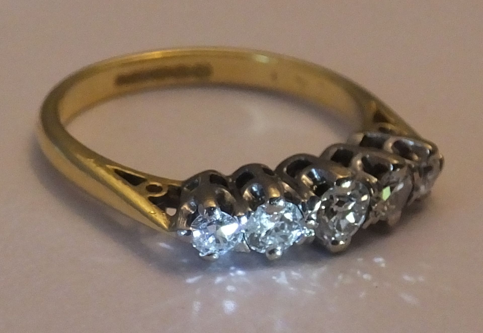 An 18ct gold diamond five-stone ring. Size J. The graduated old-cut diamond line, to the tapered - Image 2 of 3