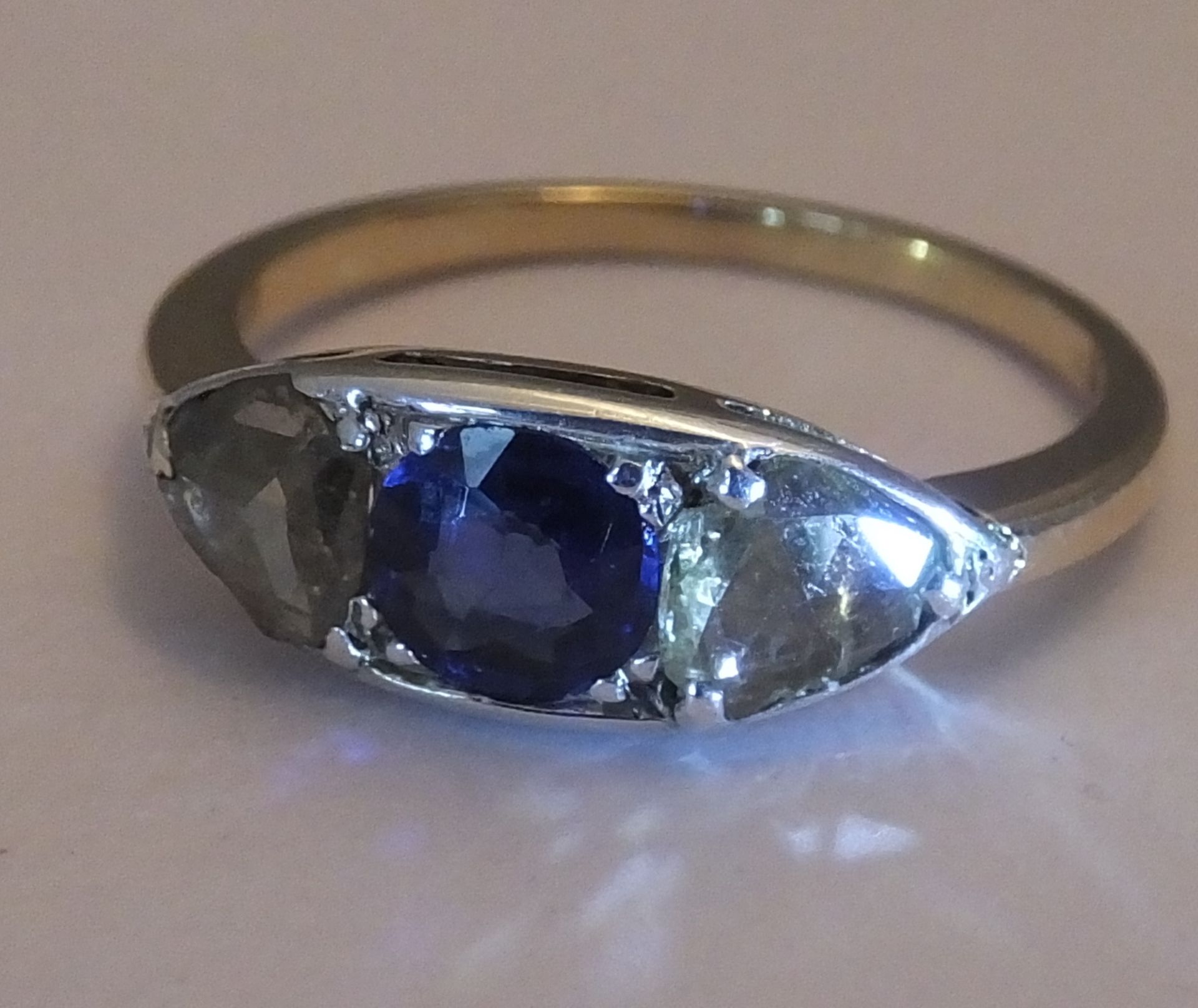 A sapphire and diamond three-stone ring. Size L - The circular-shape sapphire, with triangular-shape - Image 3 of 3