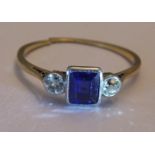 A sapphire and diamond ring. The square-shape sapphire with old-cut diamond sides to the tapered